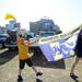 Michigan fans Kaden Churchill, 10, of Fla., and his cousin Abby Cribley, 14, of Jenison, march a Michigan flag through their tailgating section outside of Raymond James Stadium before the start of the Outback Bowl in Tampa, Fla. on Tuesday, Jan. 1. Melanie Maxwell I AnnArbor.com